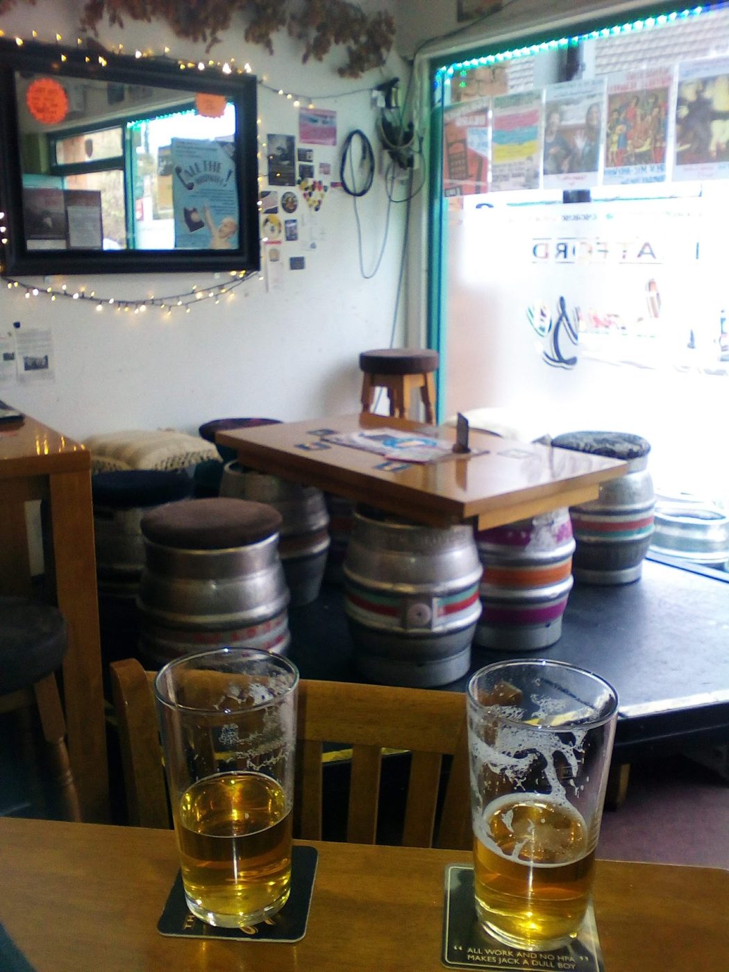 Two pints with the casks behind